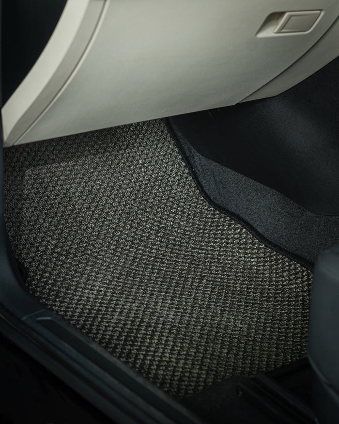 Nerova Kari Tiger Eye natural sisal car mats fully installed in BMW X3 — front and rear rows, charcoal sisal with cream leather interior