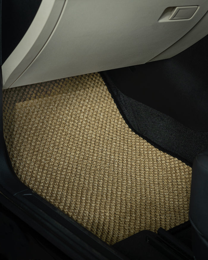 Nerova Sahara sisal mats fully installed in car — warm sand natural sisal front and rear rows